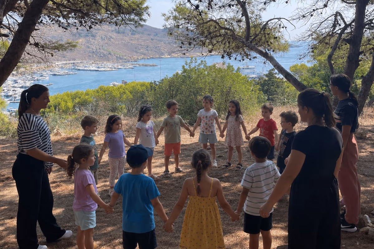Children holding hands in a circle under pine trees above a harbour at a Camp Willingness camp