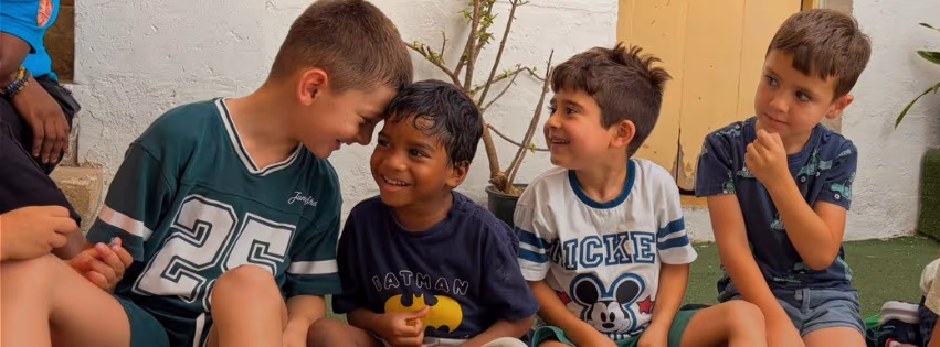 Children laughing together outdoors at Camp Willingness
